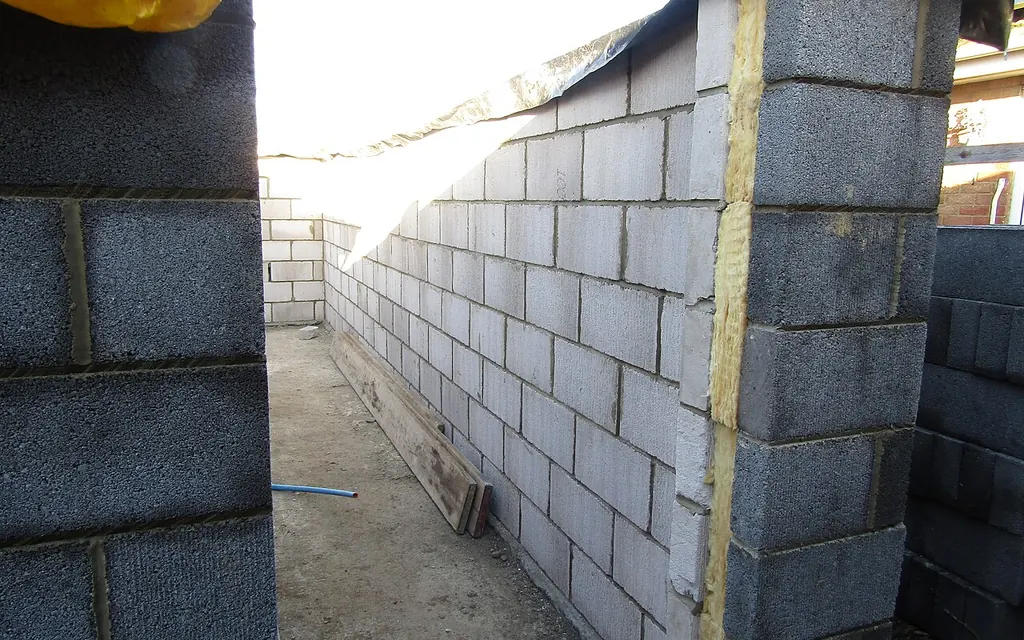 A cavity wall being built, showing the gap between the inner block wall and the outer wall